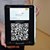 Die hellblaue Ehrenamtskarte über einem QR-Code auf einem Ipad