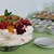 Nachspeisenbuffet mit Obst-Sahnetorte links und Schälchen und Gläsern